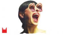 We Want You to Watch. Female head with wide open mouth and wide open mouths for eyes